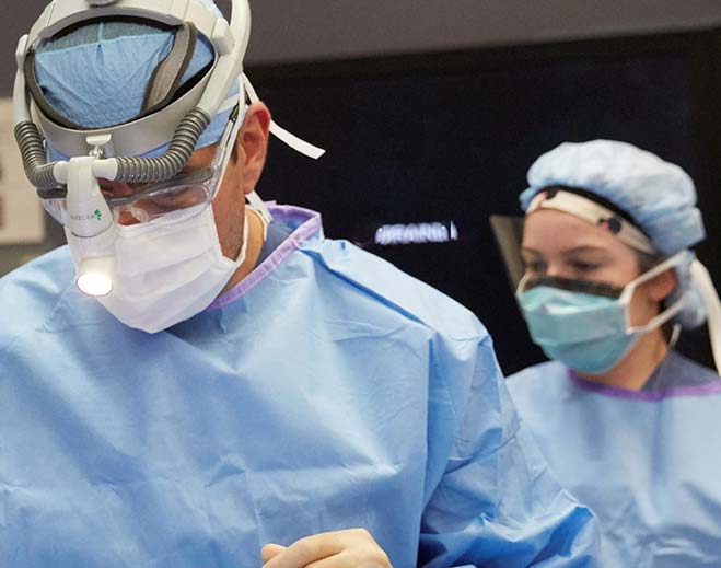 Surgical team performing procedure in operating room